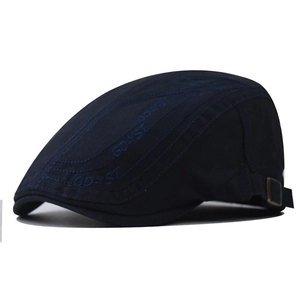 Detail of navy cotton flat cap showing adjustable metal buckle and GD-YST side embroidery