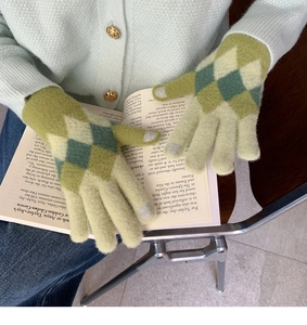 Close-up of green diamond pattern knit gloves with touch screen fingertips for winter