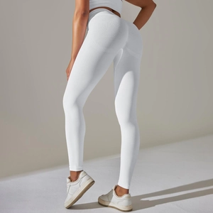Detail view of white seamless high-waisted yoga leggings showing peach butt lift seams