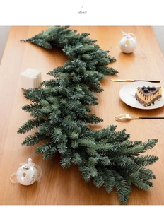 Close-up of a dense green pine needle Christmas garland used for holiday table decoration