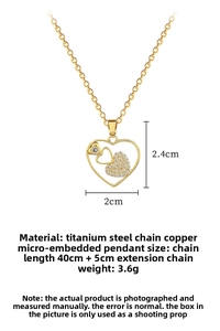 Detailed view of hollow heart pendant with white crystals on a gold-plated titanium chain