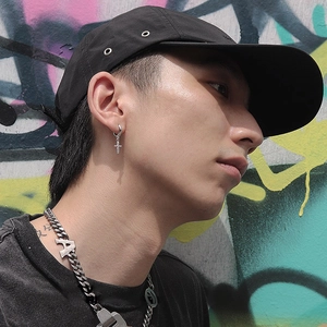 Silver cross hoop earrings with rhinestones on street model with graffiti background