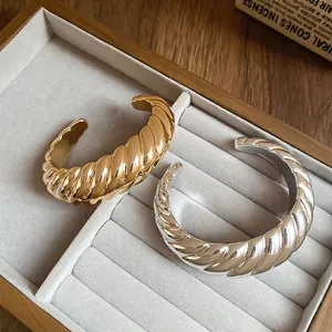 Irregular twisted open bangle bracelets in gold and silver finish for women