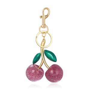 Detail of pink glitter cherry keychain with gold hardware and lobster clasp