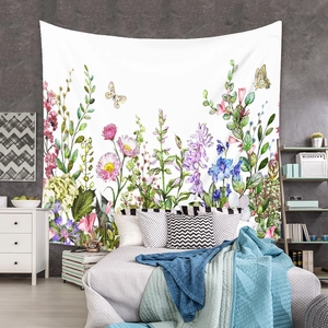 Detailed view of bohemian floral tapestry hanging on a bedroom wall with colorful botanicals