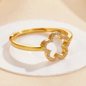 Macro shot of gold-plated silver flower ring with white cubic zirconia micro-pave details