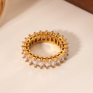 Close-up of gold-plated stainless steel ring with square-cut cubic zirconia inlays