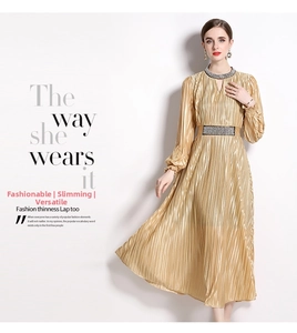 Close-up of champagne pleated dress with intricate silver rhinestone belt detail