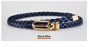 Close-up of navy blue braided thin belt with a golden horseshoe buckle and metal tip