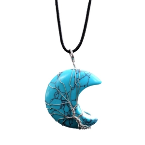 Natural blue turquoise crescent moon pendant wrapped in silver wire on a black cord necklace