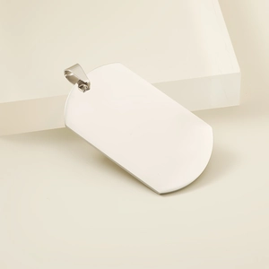 Close-up of blank stainless steel military dog tag pendant on minimalist background