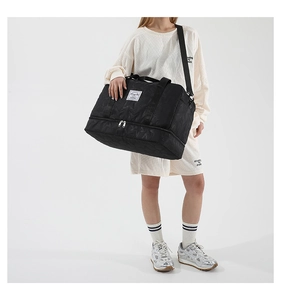 Detail of black embossed gym bag with independent shoe compartment and star pattern