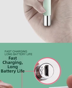 Close-up of the micro-USB charging port on a light green luminous earwax removal tool