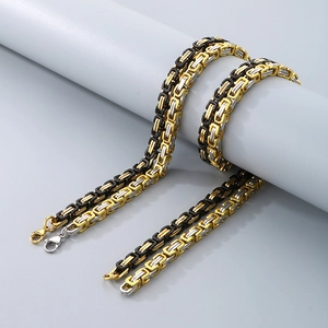 Detail of two-tone gold and black stainless steel Byzantine chain bracelet for men with clasp