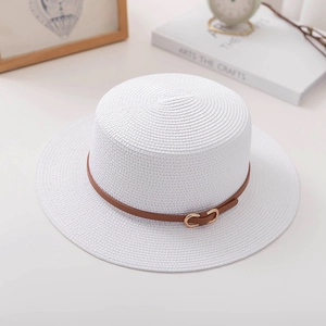 Detailed macro view of white straw boater hat with a brown leather strap and gold buckle