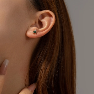 S925 silver leaf earrings with green marquise stones and pearl on model
