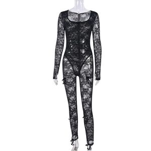 Detail of floral lace mesh pattern and bow accents on long sleeve black bodysuit
