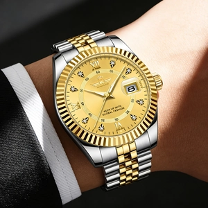 Macro shot of two-tone steel watch featuring a gold dial, roman numerals and date window