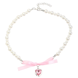 Detail of pink crystal heart pendant and ribbon bow on double-layer pearl necklace