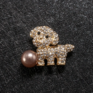 Macro detail of puppy brooch with crystals, black gemstone eyes and a purple pearl