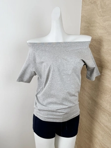 Detail view of the gray knit texture and off-shoulder neckline on a loose fit T-shirt