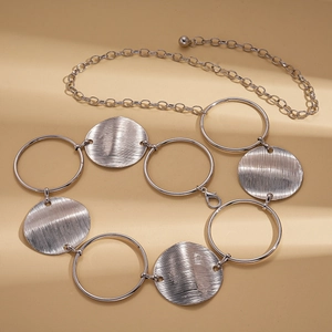 Silver metallic adjustable waist chain with textured round discs and geometric rings