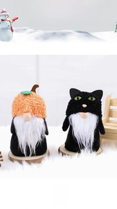 Detail of Halloween gnome plush dolls with pumpkin and black cat hats on wood bases