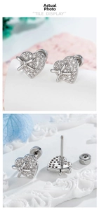 Detailed view of the zircon-inlaid heart bow stud earring with a secure screw-back closure