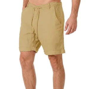 Detail of beige cotton linen shorts featuring drawstring waist and rolled hem for summer