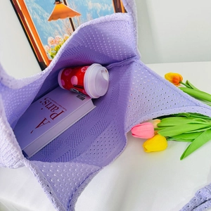 Top-down view of spacious interior and hollow-knit texture of purple shoulder bag