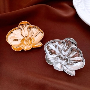 Macro shot of orchid flower brooches with realistic metallic texture and mirror finish