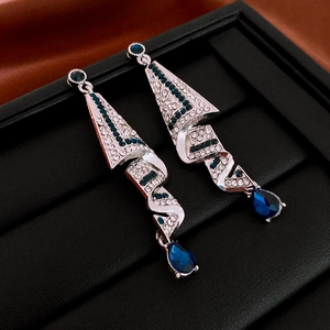 Close-up of silver drop earrings with blue water-drop stones and sparkling rhinestones