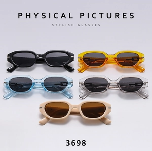 Detail view of oval cat-eye sunglasses in black, amber, blue, grey, and beige colors