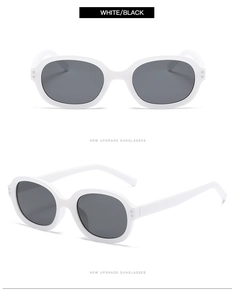 Detail view of white frame sunglasses with black lenses and classic double rivet accents