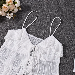Detail of white striped camisole showing ruffled texture and double tie-up neckline