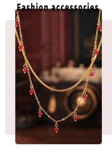 Double-layered 18K gold plated necklace featuring red beads and a flat snake chain