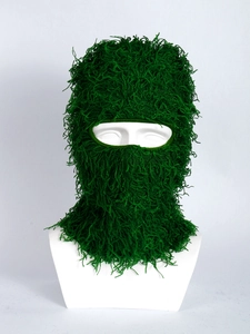 Detail view of forest green shaggy knit balaclava mask on mannequin for winter warmth