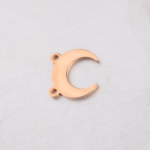 Macro detail of rose gold crescent moon pendant with double loops for DIY jewelry making