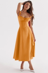 Detail of an orange strap dress with a slim waist and retro A-line skirt silhouette