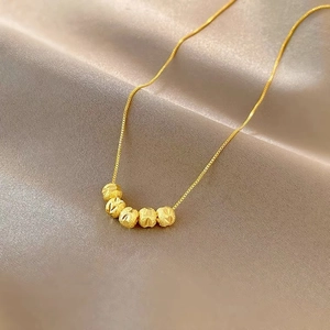 Vintage gold ball pendant necklace with five textured beads on a minimalist fine chain