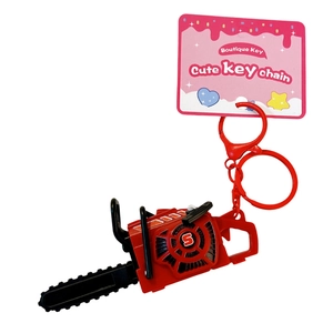 Mini vibrating red chainsaw keychain pull-string toy with a cute pink display card