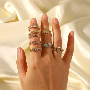 18K gold plated rings with cubic zirconia in leaf and chain designs on silk backdrop