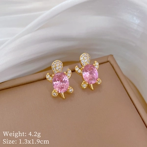Macro shot of pink turtle earrings in gold finish with sparkling zircon details