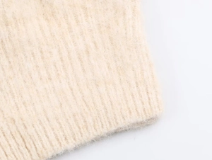 Close-up of beige ribbed knit fabric showing the soft brushed mohair texture