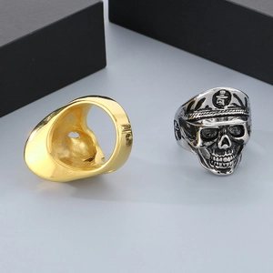 Macro detail of gothic punk silver skull ring with military hat and polished gold band