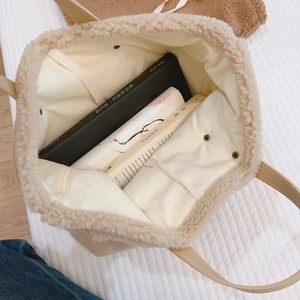 Cream canvas tote bag with fleece trim and spacious interior for daily essentials