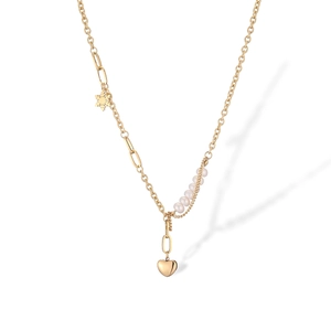Detailed close-up of a gold heart and snowflake pendant necklace with white pearls