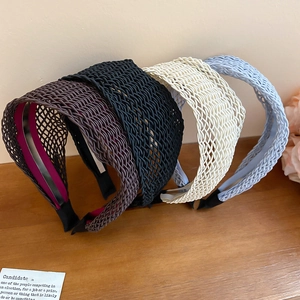 Detailed macro view of woven wide headband texture in four assorted earthy colors