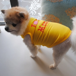 Close-up of a yellow cotton dog vest featuring a red I Love MOM print on the back