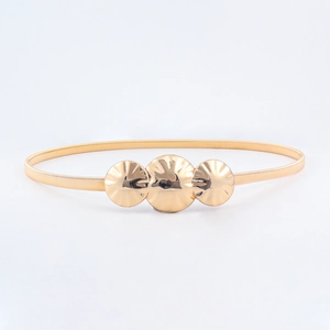 Detail of golden elastic spring waist belt featuring triple circular textured buckles